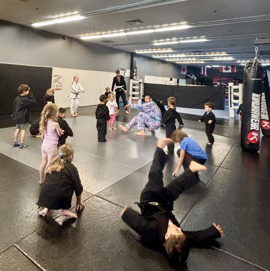 Kids playing movement games on the mats at Rumble Martial Arts.