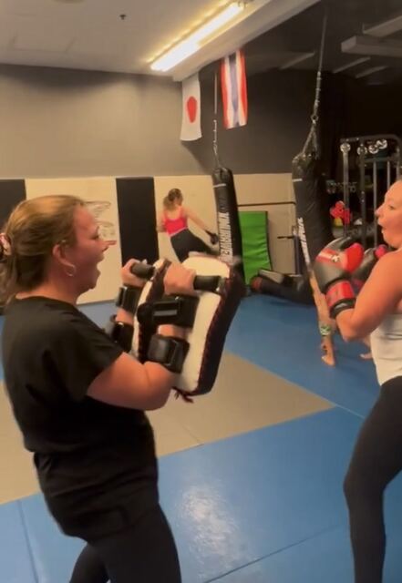 Women training with Thai pads in the Battle Girl Bootcamp at Rumble Martial Arts.