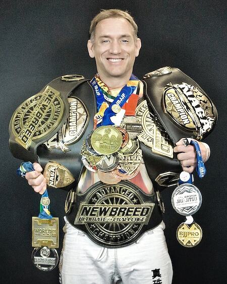 Professor Jones wearing his championship belts and medals.