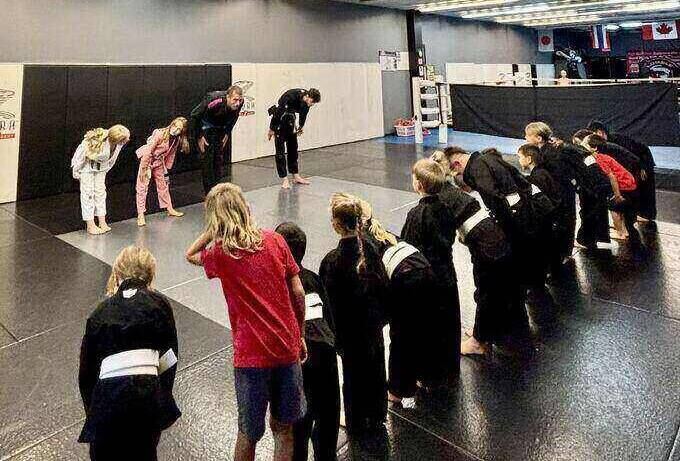 A young Rumble student lined up with the rest of the class, bowing in before training.
