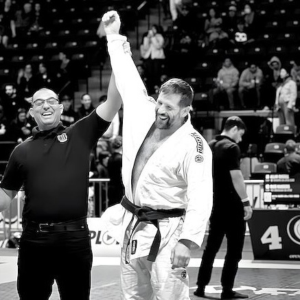 A Rumble competitor having his hand raised after a tournament win.